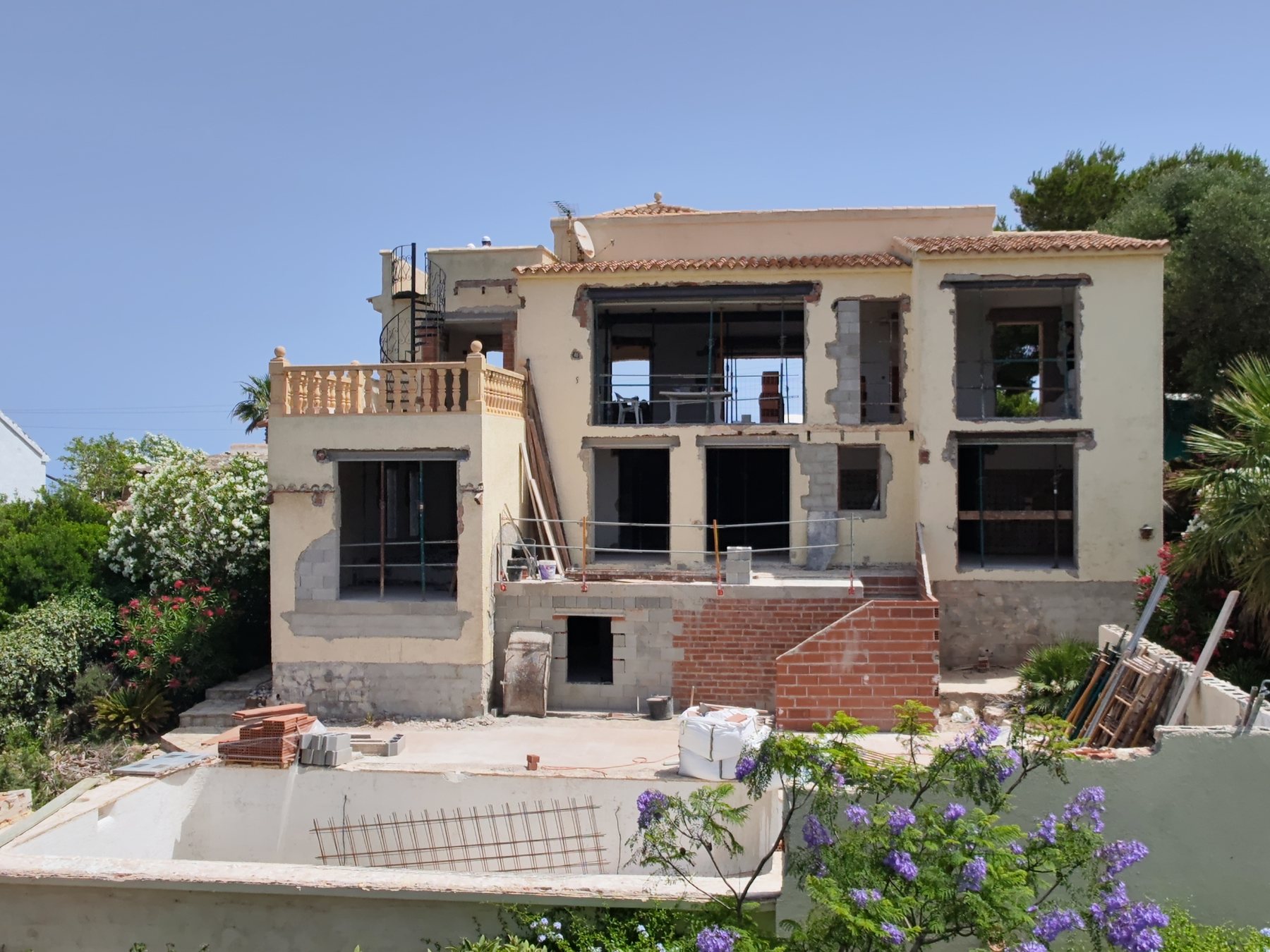 Aikido under construction: the house opened up, with new openings, scaffolding and the pool shell.