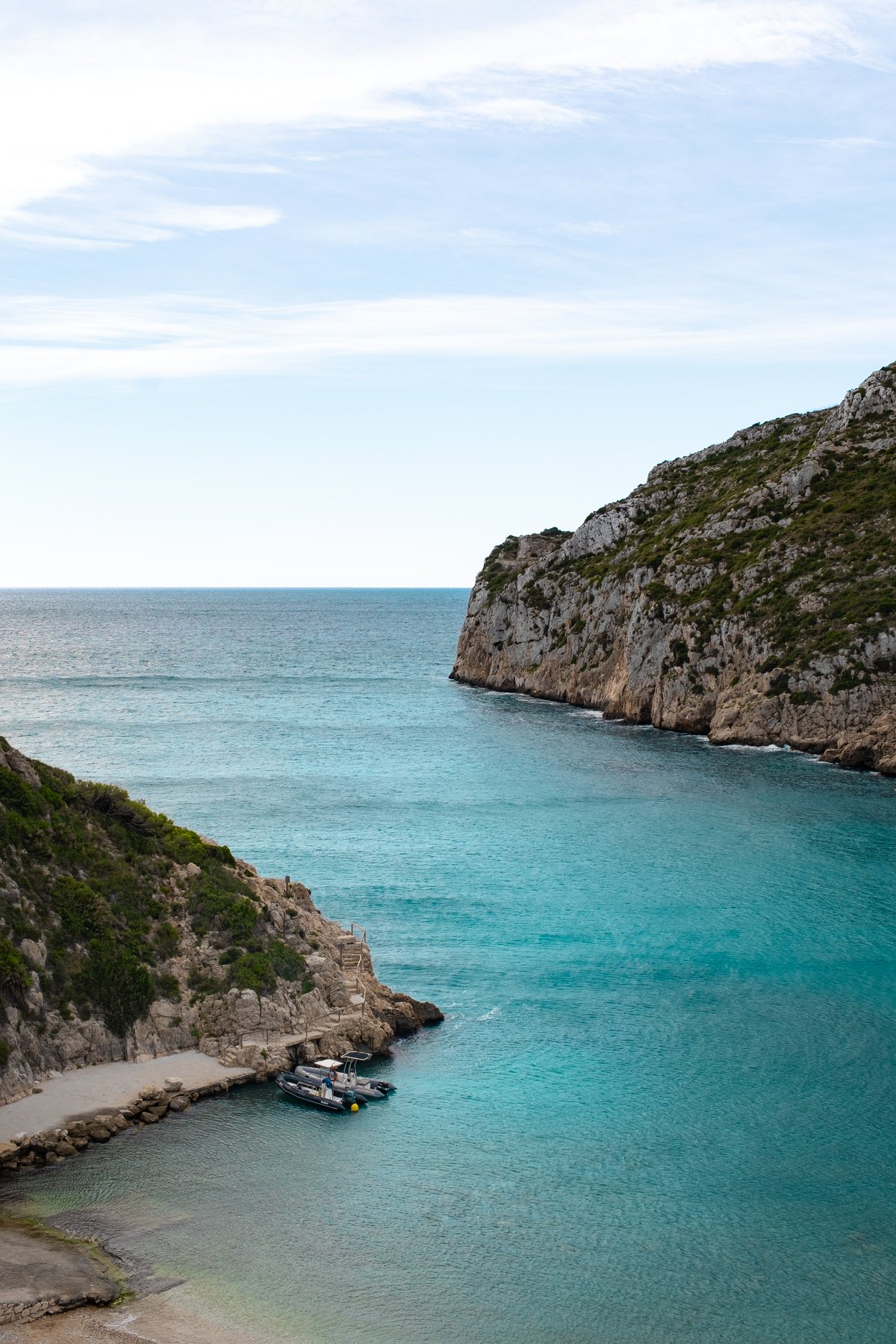 The cove of La Granadella seen from above: turquoise water between two limestone cliffs.