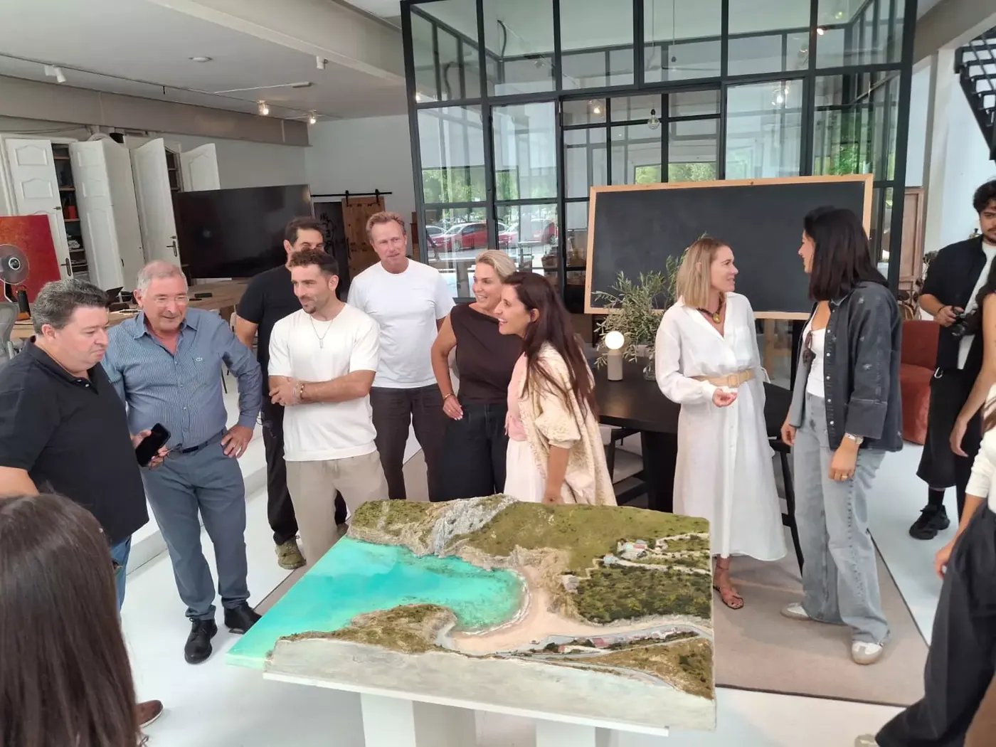 Guests gathered around the relief work during the presentation at the atelier.